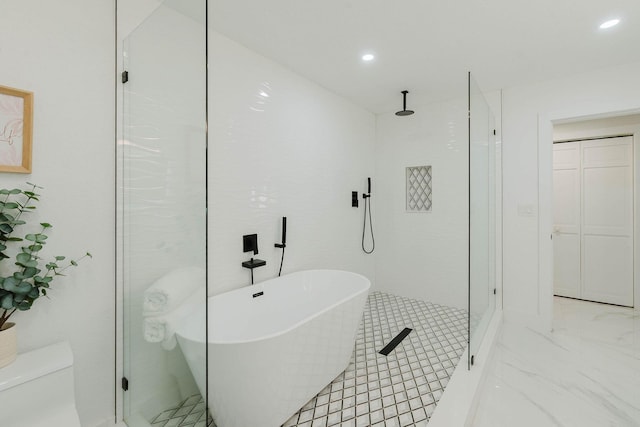 full bathroom featuring a soaking tub, toilet, a shower stall, and recessed lighting
