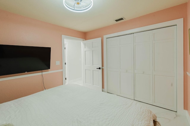 unfurnished bedroom with a closet, visible vents, and marble finish floor