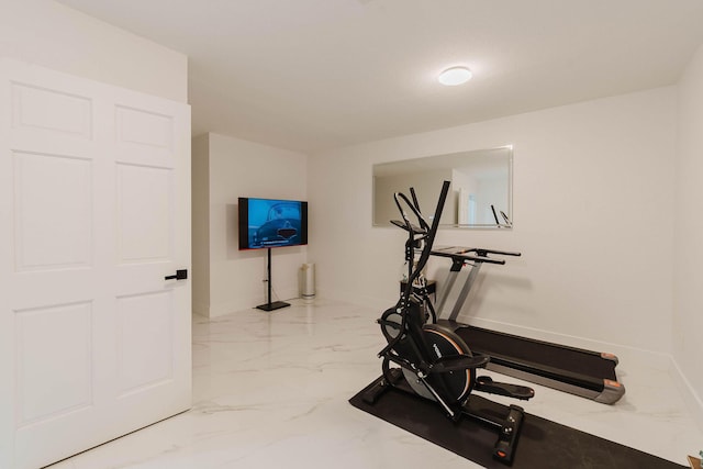 workout area with baseboards and marble finish floor