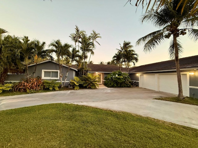 16250 SW 274th St, Homestead, FL 33031 - single story home with driveway, an attached garage, a yard, and stucco siding
