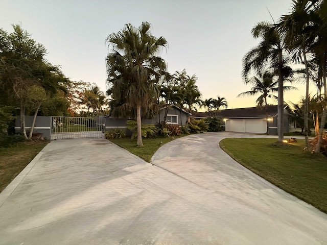 16250 SW 274th St, Homestead, FL 33031 - view of front facade with concrete driveway, a gate, and a front lawn