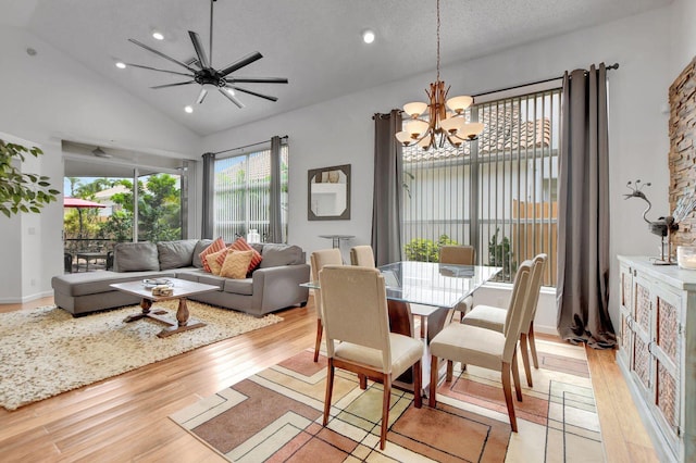 dining room with a chandelier, light wood finished floors, lofted ceiling, a ceiling fan, and recessed lighting