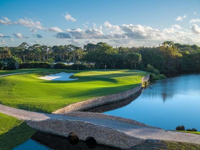 view of community with a water view and view of golf course