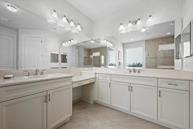 full bath with a stall shower, two vanities, and tile patterned flooring