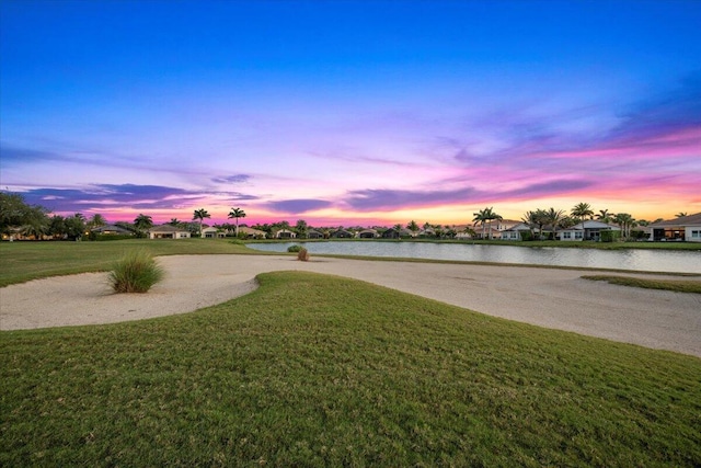view of community featuring a water view, a yard, and a residential view