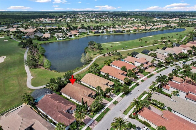 aerial overview of property's location featuring nearby suburban area, a large body of water, and a local golf course