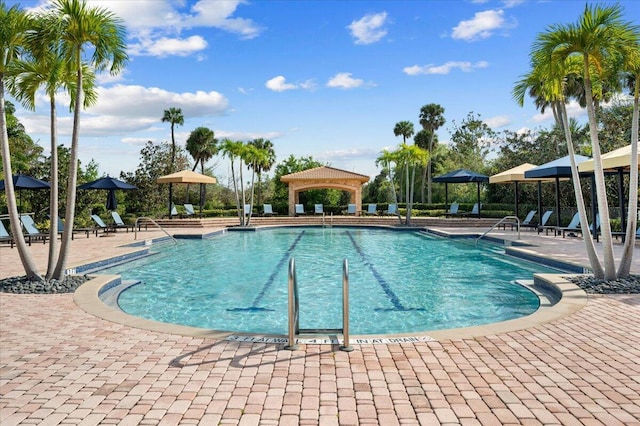 community pool featuring a gazebo and a patio area