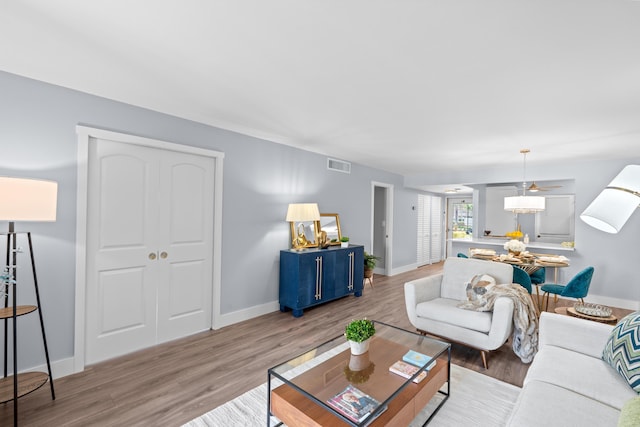 living room featuring light wood-type flooring and baseboards