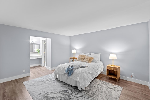 bedroom with wood finished floors and baseboards