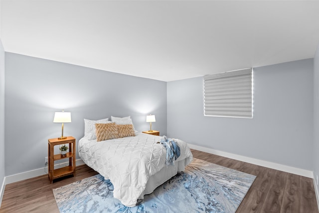 bedroom featuring wood finished floors and baseboards