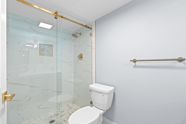 full bath with a marble finish shower and toilet