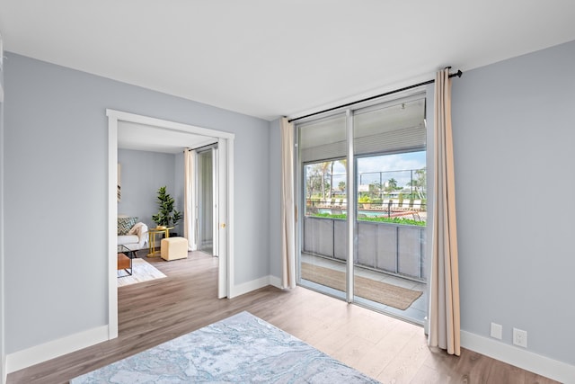 unfurnished room with wood finished floors and baseboards