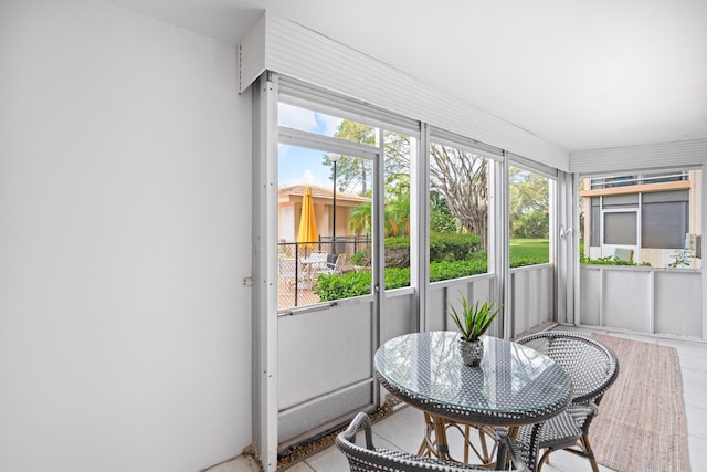 sunroom / solarium featuring outdoor dining space