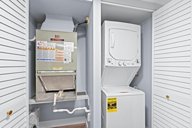 clothes washing area with estacked washer and dryer