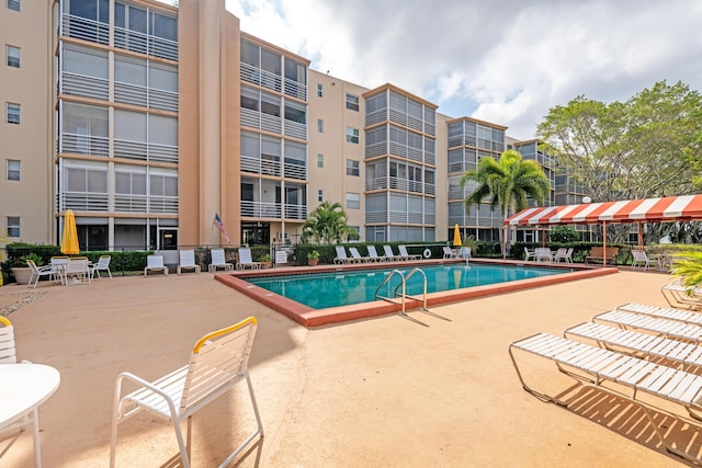 community pool with a patio area