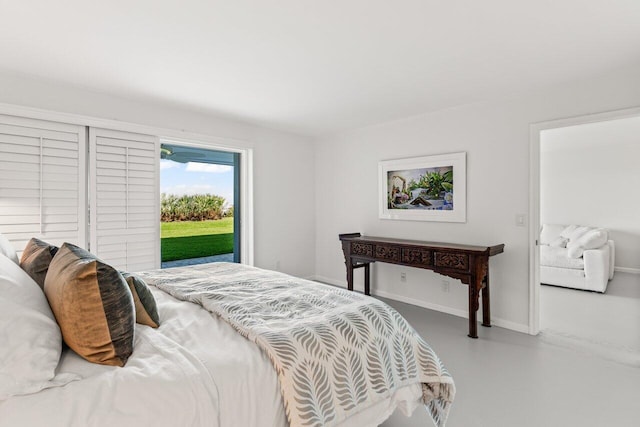 120 Celestial Way Unit 113, Juno Beach, FL 33408 - bedroom featuring access to exterior, concrete floors, and baseboards