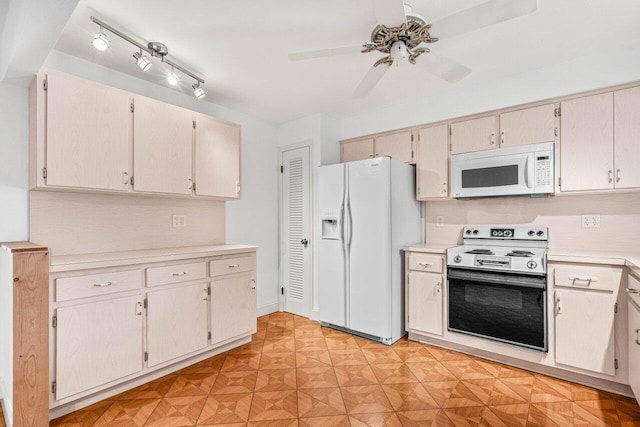kitchen with white appliances, light countertops, and ceiling fan