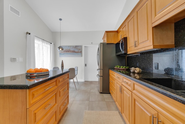 kitchen featuring tasteful backsplash, hanging light fixtures, stainless steel microwave, lofted ceiling, and visible vents