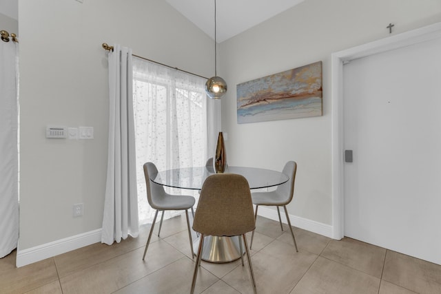 dining area with lofted ceiling and baseboards