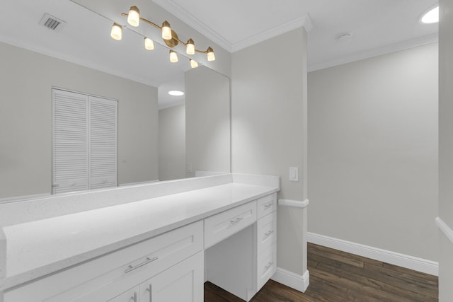 bathroom with baseboards, visible vents, wood finished floors, crown molding, and vanity