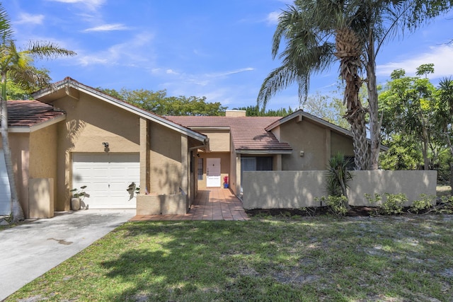 mid-century inspired home featuring a tile roof, concrete driveway, fence, a garage, and stucco siding