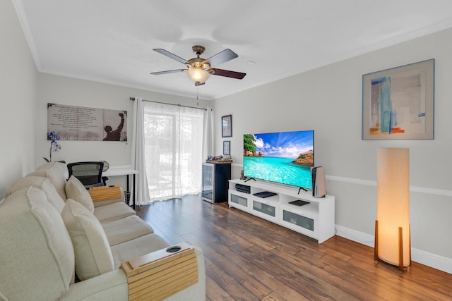 living area featuring baseboards, a ceiling fan, ornamental molding, and hardwood / wood-style flooring