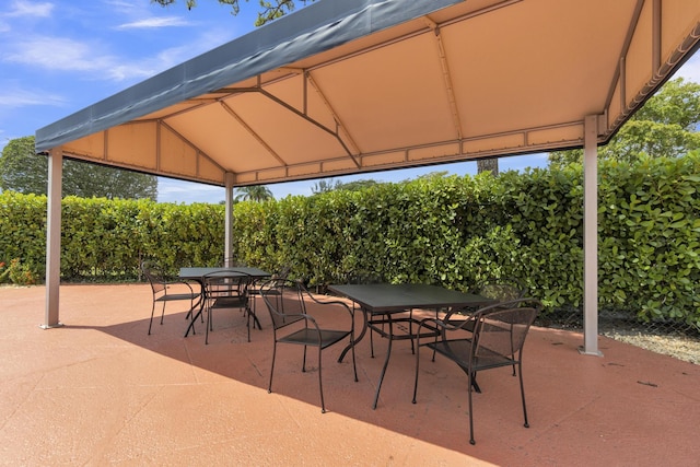 view of patio featuring outdoor dining area and a gazebo