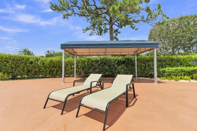 view of patio with a gazebo and fence