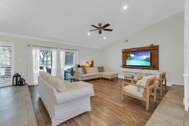 living area with lofted ceiling, a ceiling fan, crown molding, and plenty of natural light