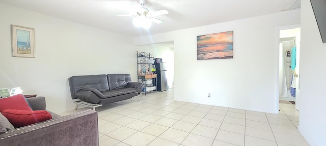 living area with light tile patterned floors and a ceiling fan