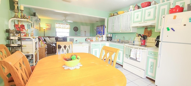 kitchen with light tile patterned floors, a sink, a ceiling fan, white appliances, and under cabinet range hood