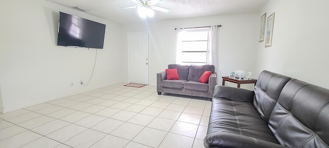 living area with visible vents, a ceiling fan, and light tile patterned floors