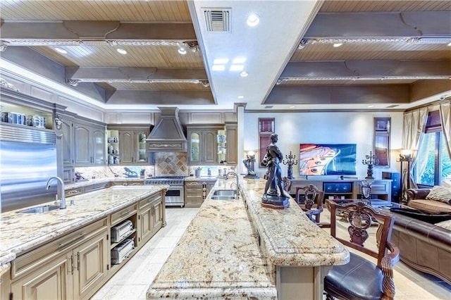 3131 NE 27th Ave, Lighthouse Point, FL 33064 - kitchen with wooden ceiling with exposed beams, custom exhaust hood, a sink, glass insert cabinets, and high quality appliances