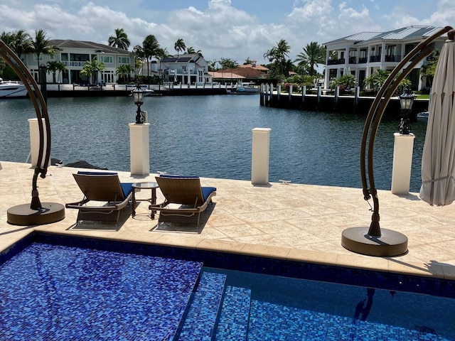 3131 NE 27th Ave, Lighthouse Point, FL 33064 - outdoor pool with a water view, a dock, and a patio area