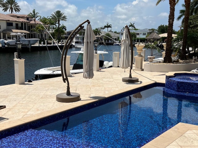 3131 NE 27th Ave, Lighthouse Point, FL 33064 - swimming pool featuring a boat dock, an in-ground hot tub, a water view, and a patio area
