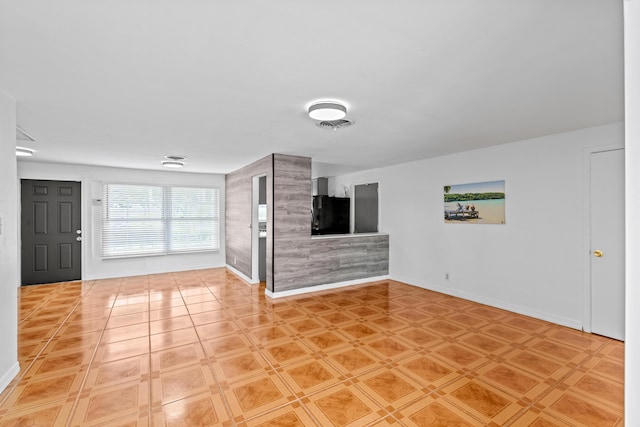3700 N Australian Ave, West Palm Beach, FL 33407 - unfurnished living room featuring baseboards