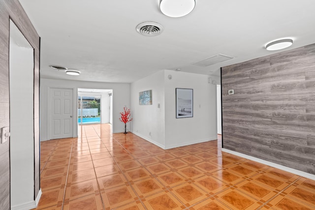 3700 N Australian Ave, West Palm Beach, FL 33407 - spare room featuring baseboards and wood walls