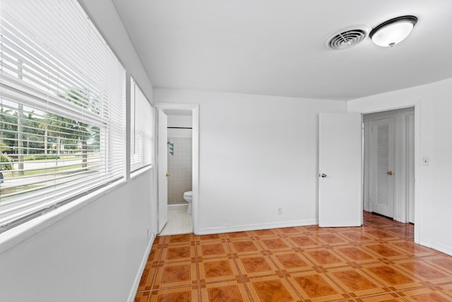 3700 N Australian Ave, West Palm Beach, FL 33407 - unfurnished bedroom with baseboards and ensuite bathroom