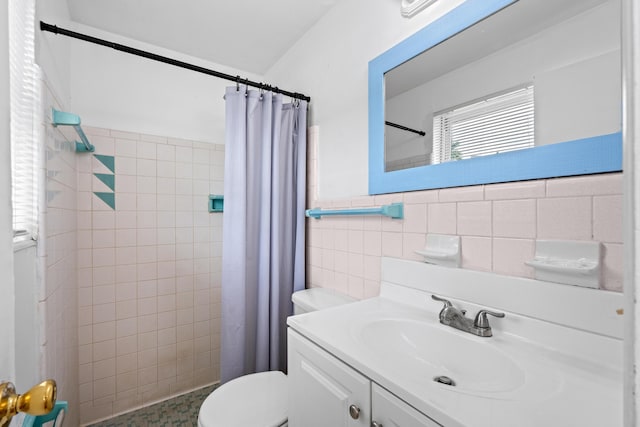 3700 N Australian Ave, West Palm Beach, FL 33407 - bathroom with tile walls, toilet, a tile shower, and vanity