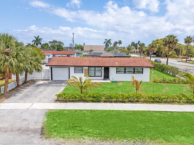 3700 N Australian Ave, West Palm Beach, FL 33407 - ranch-style house featuring asphalt driveway, an attached garage, solar panels, and stucco siding