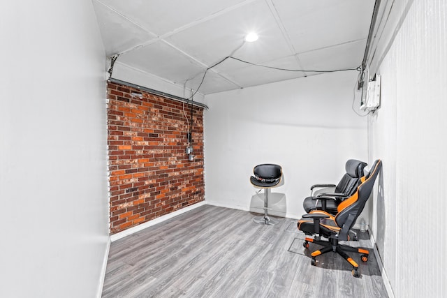 3700 N Australian Ave, West Palm Beach, FL 33407 - living area with wood finished floors, baseboards, and brick wall