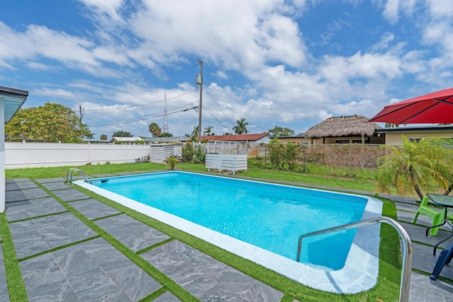 3700 N Australian Ave, West Palm Beach, FL 33407 - view of swimming pool featuring a fenced backyard, a patio, an outbuilding, and a shed