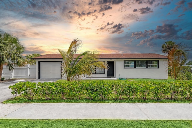 3700 N Australian Ave, West Palm Beach, FL 33407 - single story home with stucco siding, an attached garage, fence, and driveway