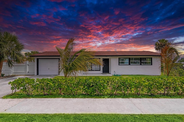 3700 N Australian Ave, West Palm Beach, FL 33407 - single story home featuring stucco siding, an attached garage, driveway, and fence
