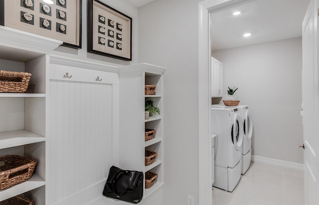 laundry room with cabinet space, washing machine and dryer, light tile patterned flooring, baseboards, and recessed lighting