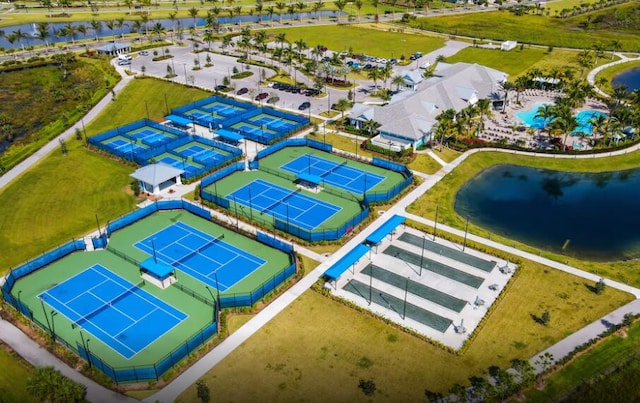 drone / aerial view of a large body of water and a pool area
