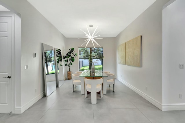 dining area with a chandelier, finished concrete flooring, and baseboards