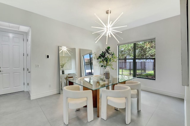 dining room featuring a chandelier, light tile patterned floors, and baseboards