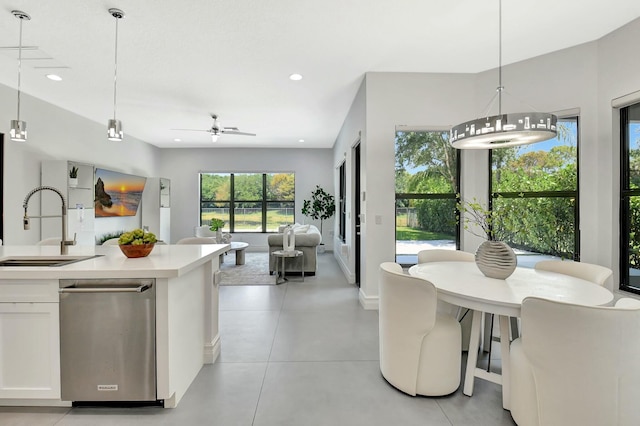 kitchen featuring open floor plan, a sink, white cabinetry, and recessed lighting