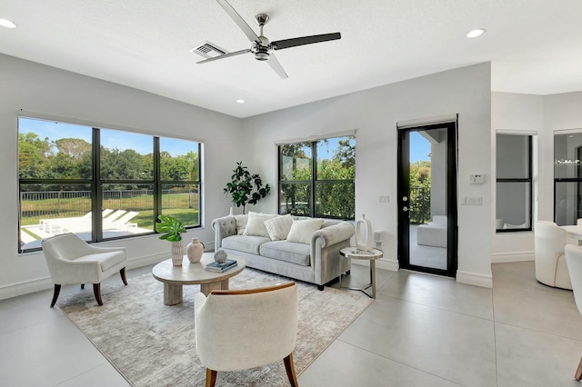 living room featuring visible vents, a ceiling fan, recessed lighting, and a healthy amount of sunlight